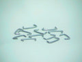 Durable metal upholstery hooks designed for securely mounting and attaching fabric or leather upholstery to furniture frames. One bag contains 100 hooks.